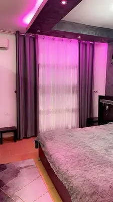 a bedroom with purple curtains and a bed at شقةارضية فاخرة مفروشة عمان ضاحية الرشيد in Ţāb Kirā‘
