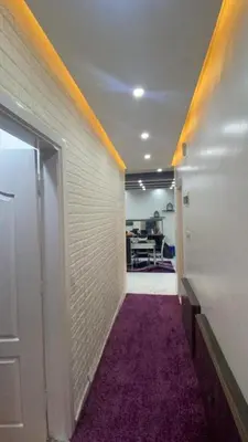 an office hallway with a room with a purple carpet at شقةارضية فاخرة مفروشة عمان ضاحية الرشيد in Ţāb Kirā‘