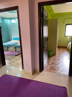 a living room with a purple rug and a bedroom at Luxury Duplex In the center of Irbid -Spacious 4BR in Irbid