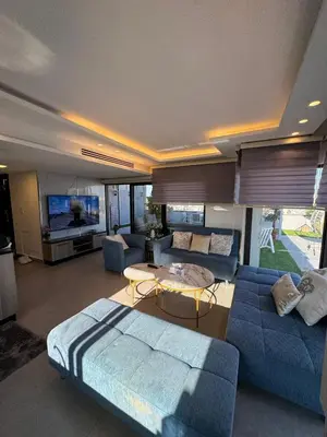 a living room with a blue couch and a table at The Roof Top Lounge in Umm Uthainah