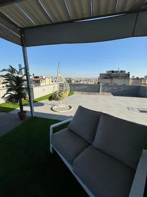 a couch sitting on top of a roof at The Roof Top Lounge in Umm Uthainah