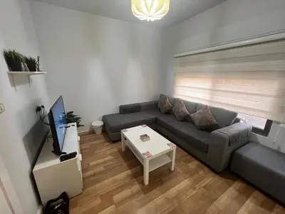 a living room with a couch and a table at Cozy & Comfortable Studio in the heart of Amman, Studio #17 in Umm Uthainah