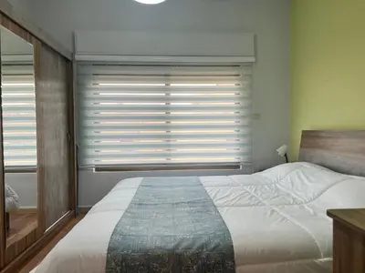 a bedroom with a bed and a window with blinds at Cozy & Comfortable Studio in the heart of Amman, Studio #17 in Umm Uthainah
