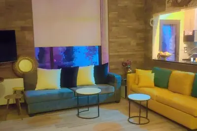 a living room with a couch and two tables at villa rose3 in Mūbiş