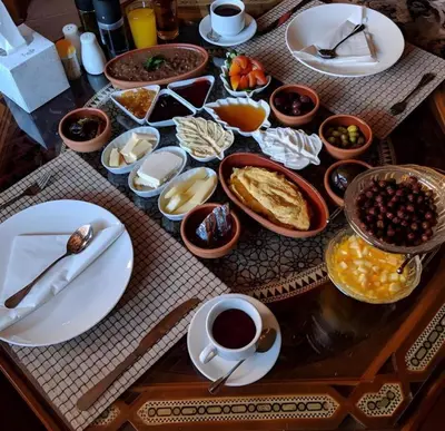 a table with plates and bowls of food on it at Bedouin Camp&tour in Wadi Rum