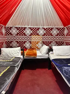 a room with two beds in a tent at Bedouin Camp&tour in Wadi Rum