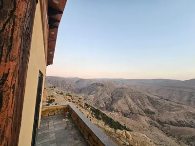 a view of the desert from a balcony of a building at Ramses Tafilah Lodge نزل رمسيس الطفيلة in At-Tafilah