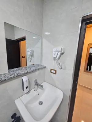 a bathroom with a sink and a mirror at Ramses Tafilah Lodge نزل رمسيس الطفيلة in At-Tafilah