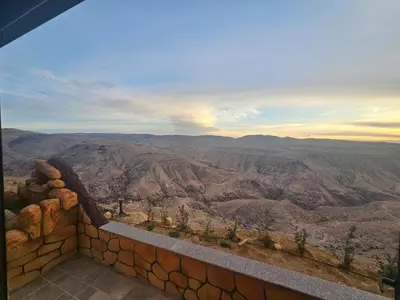 a view of the grand canyon from the edge of a wall at Ramses Tafilah Lodge نزل رمسيس الطفيلة in At-Tafilah