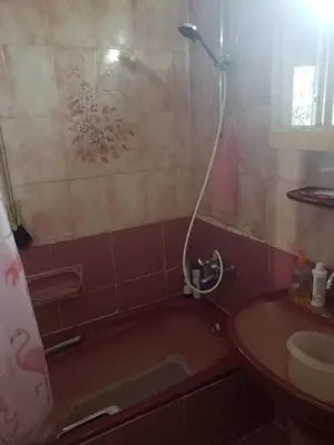 a bathroom with a bath tub and a sink at Al Otaibi in Umm Uthainah