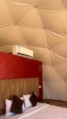 a bedroom with a bed with a ceiling with a heater at مخيم in Disah