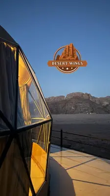 a glass building with a view of the desert views at RUM WINGS BUBBLES lUXURY CAMP in Wadi Rum