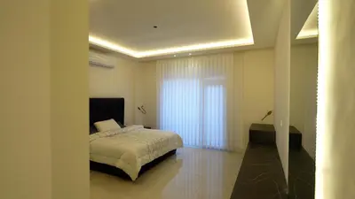 a bedroom with a bed and a window at Open sooq in Al Bunayyāt ash Shamālīyah