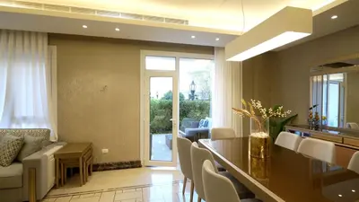 a living room with a couch and a table and chairs at Open sooq in Al Bunayyāt ash Shamālīyah