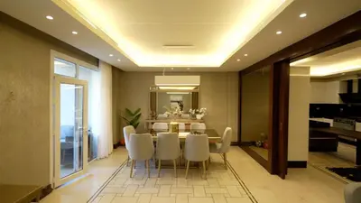 a dining room with a table and white chairs at Open sooq in Al Bunayyāt ash Shamālīyah