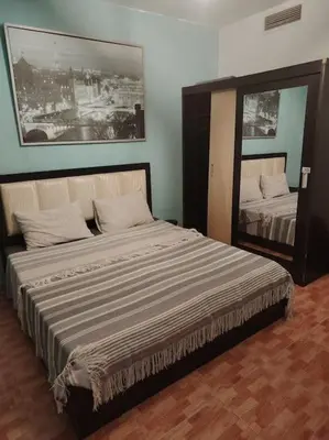 a bedroom with a large bed and a mirror at Cozy modern 2 bedroom apartment in Amman