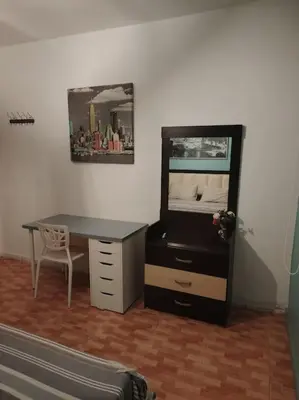 a bedroom with a desk and a bed with a mirror at Cozy modern 2 bedroom apartment in Amman
