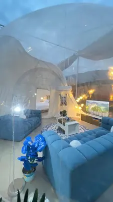 a living room with blue couches and a table at منتجع برمودا Bermuda resort in Ajloun