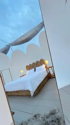 a bed in a room with a glass wall at منتجع برمودا Bermuda resort in Ajloun