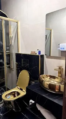 a bathroom with a toilet and a sink at Modern & New 3-BR Entire Apt - Prime Location! in Rujm ash Sharāʼirah