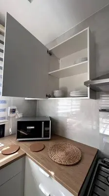a kitchen with a counter top with a microwave at Modern & New 3-BR Entire Apt - Prime Location! in Rujm ash Sharāʼirah