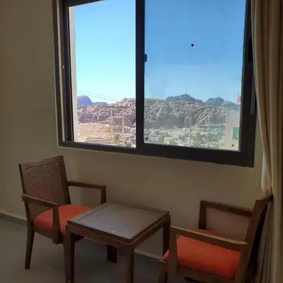 a room with two chairs and a window with a view at Petra Summit Hotel in Petra