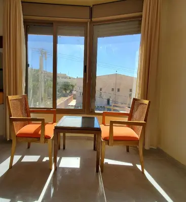 a room with a table and two chairs and a window at Petra Summit Hotel in Petra