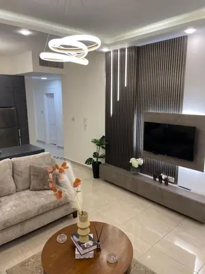 a living room with a couch and a table at السابع in Amman