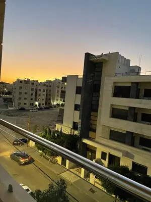 a view of a building with a parking lot at السابع in Amman