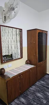 a wooden cabinet with a mirror and a fan at Travelers Rest in Wadi Musa