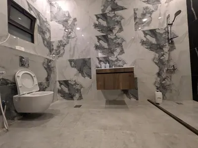 a bathroom with a toilet and a sink and a shower at Aeropuerta Mini Villa - Private self check-in Layover near Airport in Al Qasţal