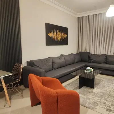 a living room with a couch and a table at Flat In Shafa Badran in Ţāb Kirā‘