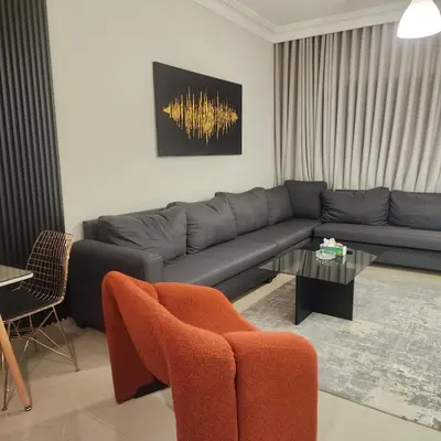 a living room with a couch and a table at Flat In Shafa Badran in Ţāb Kirā‘