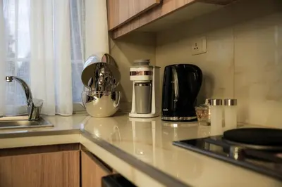 a kitchen counter with a coffee maker on it at Hawari Group in Umm Uthainah