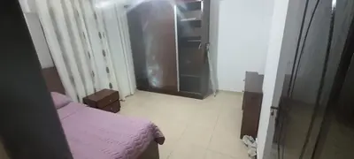 a bedroom with a pink bed and a walk in closet at Furniture apartment for families 3 bedroom in Al Bunayyāt ash Shamālīyah