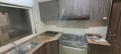 a small kitchen with a stove and a sink at Furniture apartment for families 3 bedroom in Al Bunayyāt ash Shamālīyah
