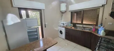 a kitchen with a refrigerator and a sink and a microwave at Furniture apartment for families 3 bedroom in Al Bunayyāt ash Shamālīyah
