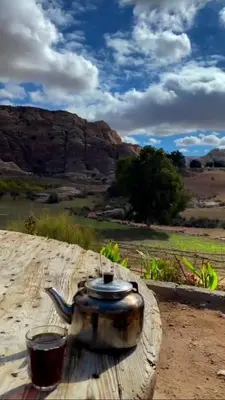 a tea pot sitting on a table in the desert at Country cottage in Al Ḩayy