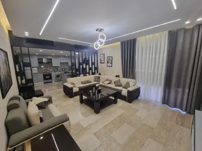 a large living room with couches and a table at Dier Ghbar 2 bedrooms-A in Amman