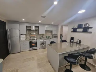 a kitchen with stainless steel appliances and a counter at Dier Ghbar 2 bedrooms-A in Amman