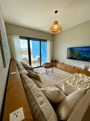 a living room with a large couch and a table at Aladdin Chalet 13 in Aqaba