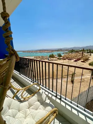 a balcony with a chair and a view of a beach at Aladdin Chalet 13 in Aqaba