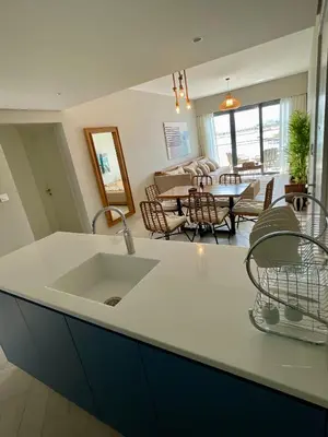a kitchen with a sink and a dining room at Aladdin Chalet 13 in Aqaba