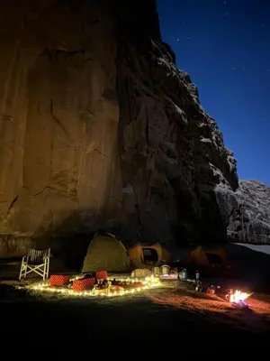 a tent with lights in front of a mountain at Camp star road safari in Wadi Rum
