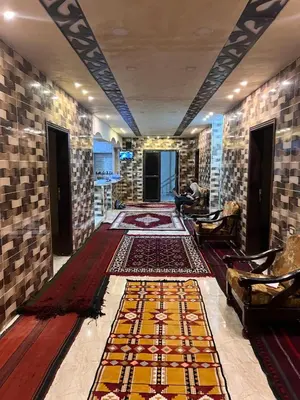 a hallway with carpets on the floor in a building at Indiana Jones Home Stay in Petra