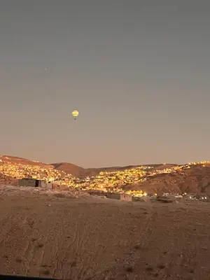 a kite flying in the sky over a city at Indiana Jones Home Stay in Petra