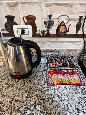 a tea kettle sitting on a counter next to a tray of food at Indiana Jones Home Stay in Petra