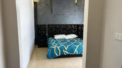 a bedroom with a bed with two pillows on it at Izz AlDin Tamimi St شقة مفروش سوبر ديلوكس الجبيهة in Ţāb Kirā‘