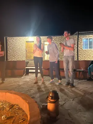 a group of people standing around a fire hydrant at Bright Stars Camp in Disah