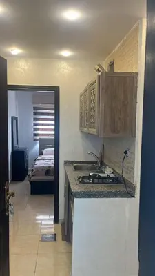 a kitchen with a sink and a counter top at الروف سوبر ديلوكس 2 غرف نوم صالة جلوس و طعام مكيفة للإيجار in Amman